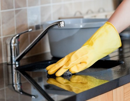 Carpet cleaner preparing equipment safely before starting a job