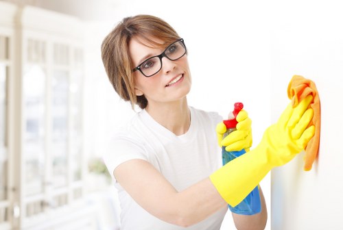 Cleaner applying safe chemical handling procedures during carpet cleaning