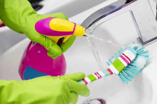 Trained carpet cleaners using professional equipment in a home setting